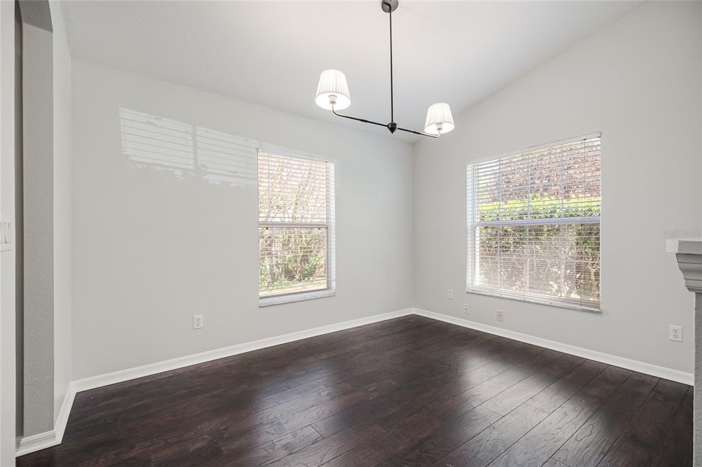221 Rosa Avenue Oviedo, FL 32765 - Photo 8 of 36 a view of an empty room with wooden floor and a window