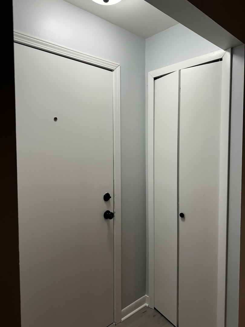 82 Luella Avenue, Unit 2 Calumet City, IL 60409 - Photo 2 of 12 a bathroom with a glass shower door