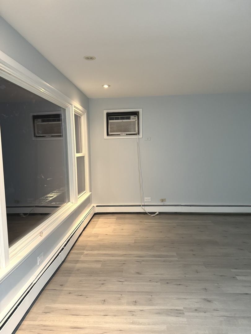 82 Luella Avenue, Unit 2 Calumet City, IL 60409 - Photo 4 of 12 a view of an empty room with a window