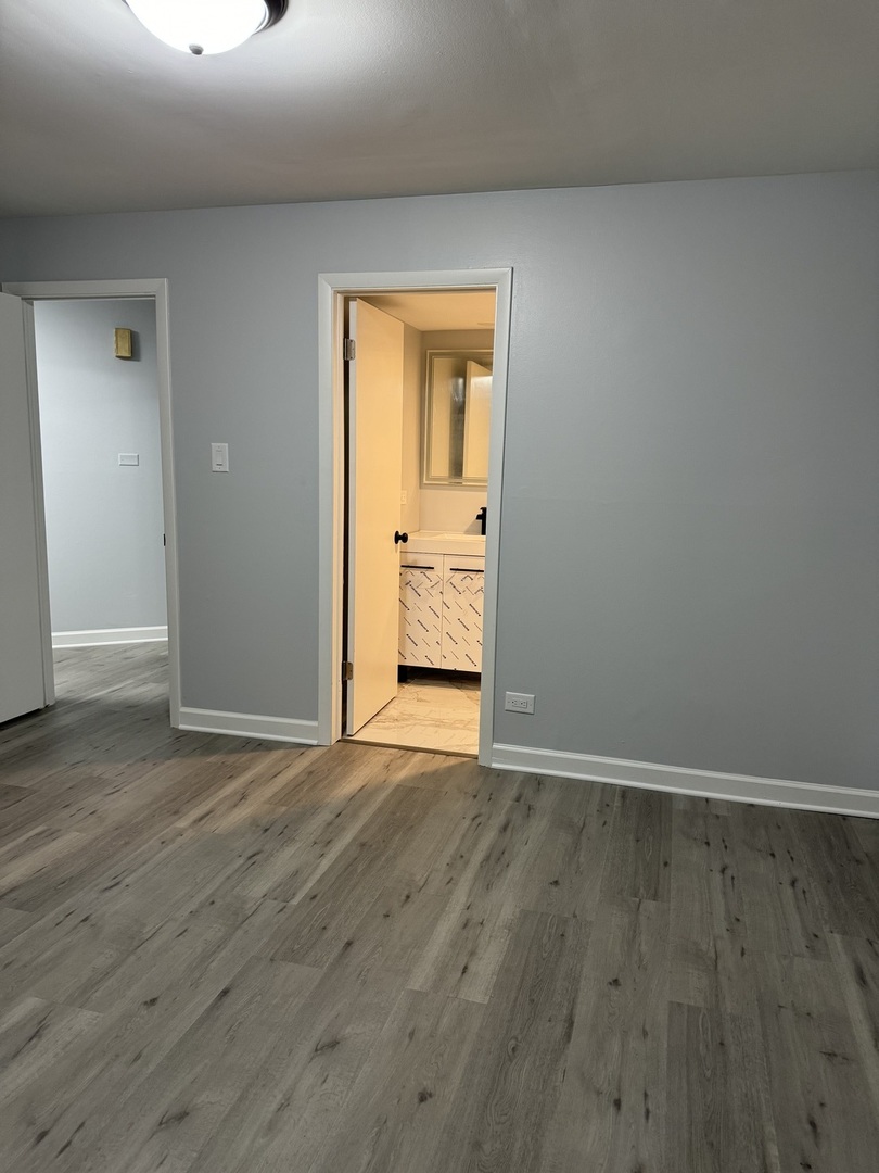 82 Luella Avenue, Unit 2 Calumet City, IL 60409 - Photo 7 of 12 a view of an empty room with wooden floor and closet