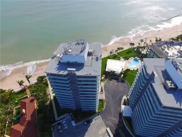 an aerial view of a house ocean view and a space