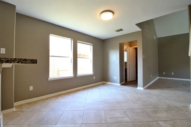 an empty room with windows and closet