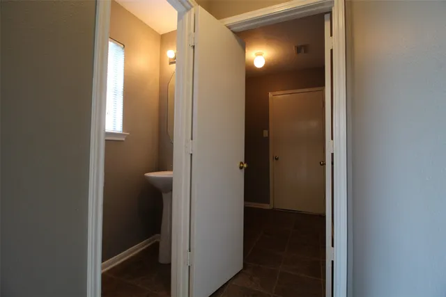 a view of a bathroom from a hallway
