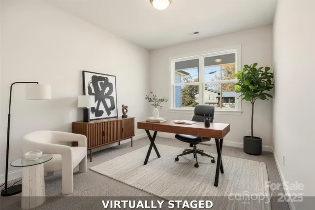 a living room with furniture a potted plant and a table