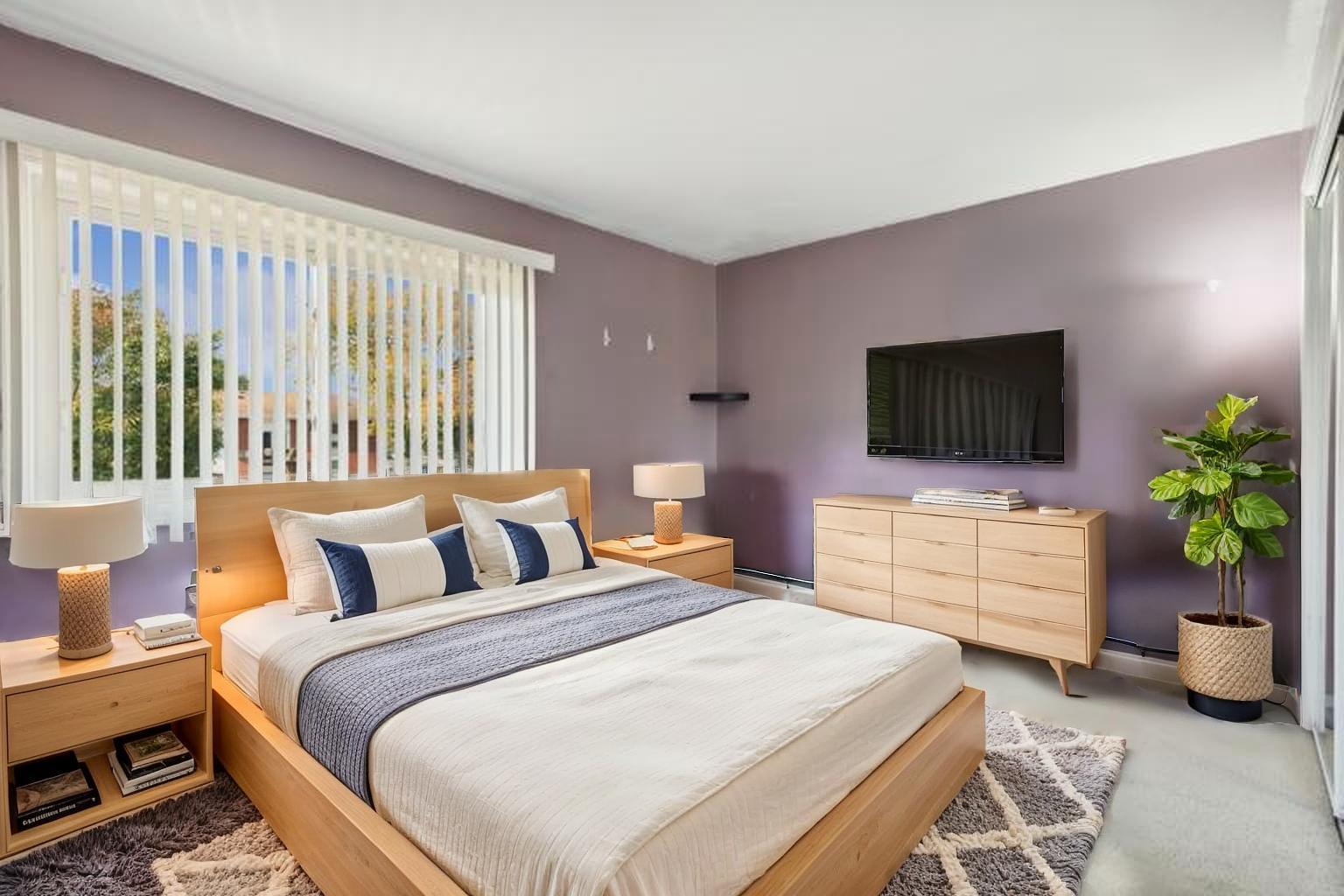 9561 Dee Road, Unit 2G Des Plaines, IL 60016 - Photo 15 of 18 a bedroom with a bed and a flat screen tv