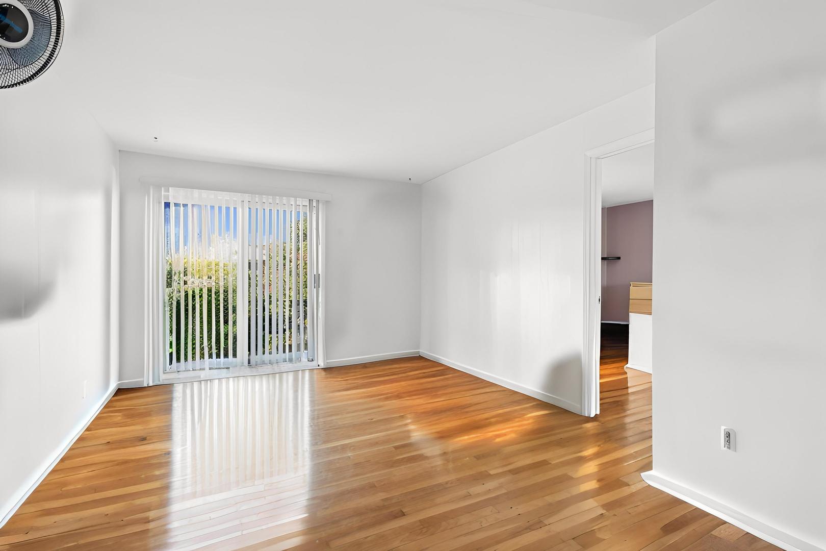9561 Dee Road, Unit 2G Des Plaines, IL 60016 - Photo 5 of 18 a view of a livingroom with wooden floor