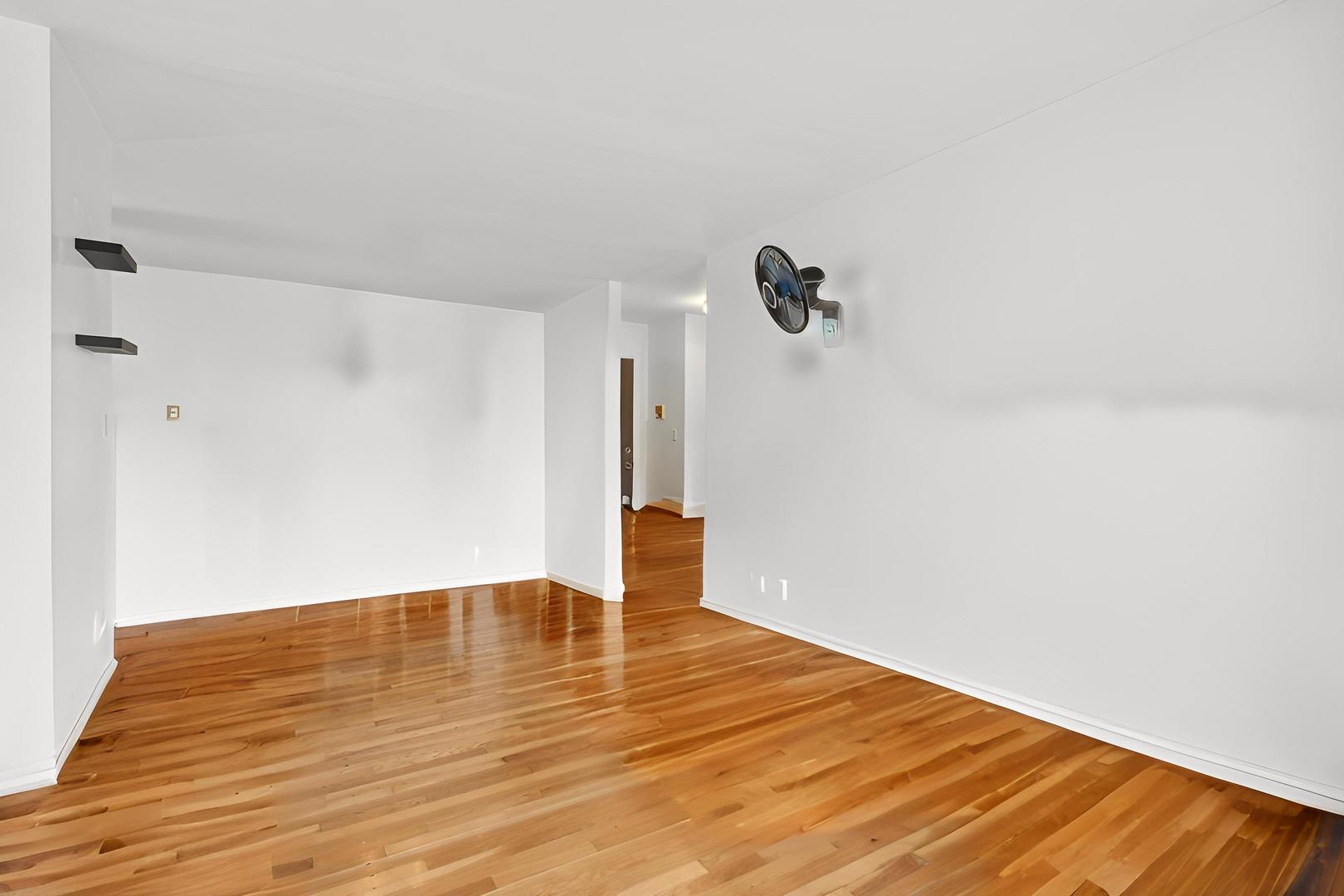 9561 Dee Road, Unit 2G Des Plaines, IL 60016 - Photo 7 of 18 a view of empty room with wooden floor