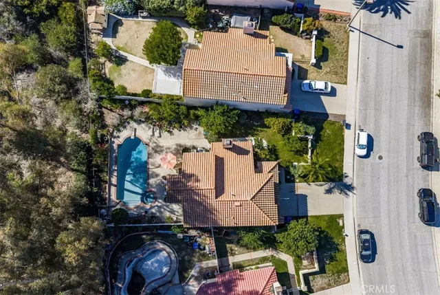 an aerial view of a house with garden space and street view