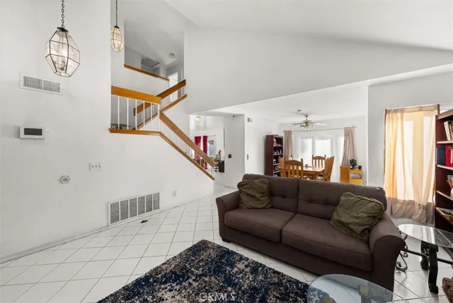 a living room with furniture and a chandelier