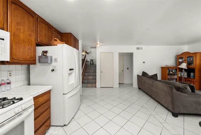 a kitchen with stainless steel appliances a refrigerator and a stove