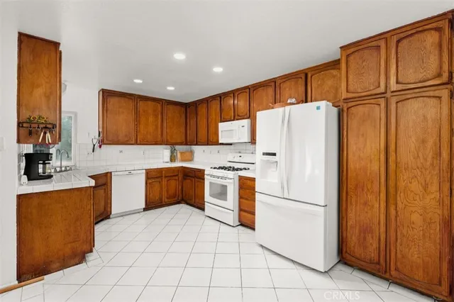 a kitchen with stainless steel appliances a refrigerator sink and cabinets