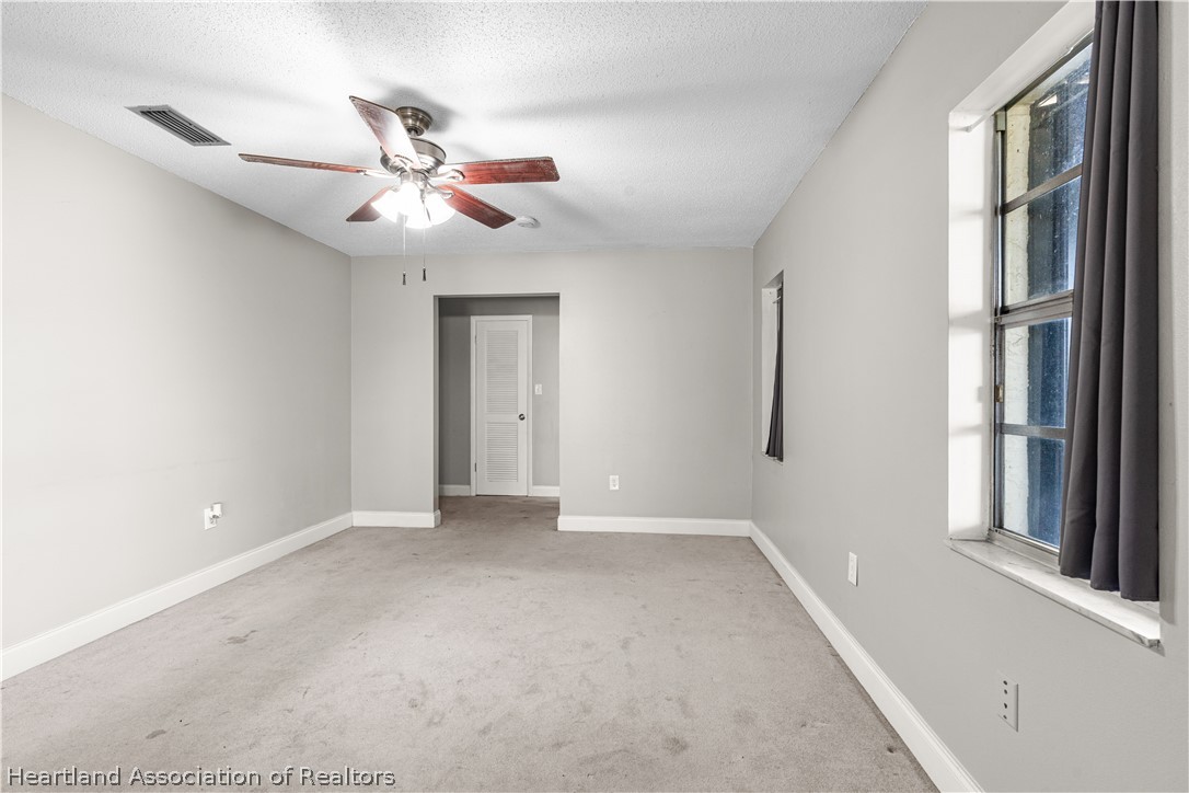 7100 Coral Ridge Road Sebring, FL 33876 - Photo 20 of 44 a view of an empty room with a window