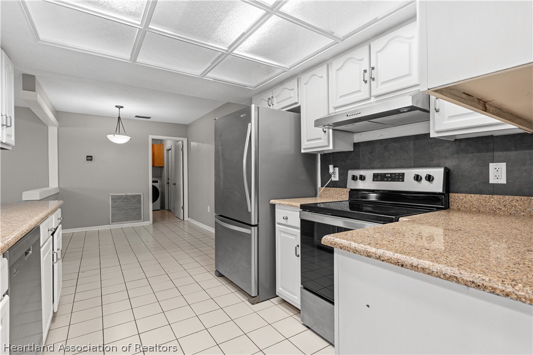 7100 Coral Ridge Road Sebring, FL 33876 - Photo 29 of 44 a kitchen with stainless steel appliances granite countertop a refrigerator and a sink