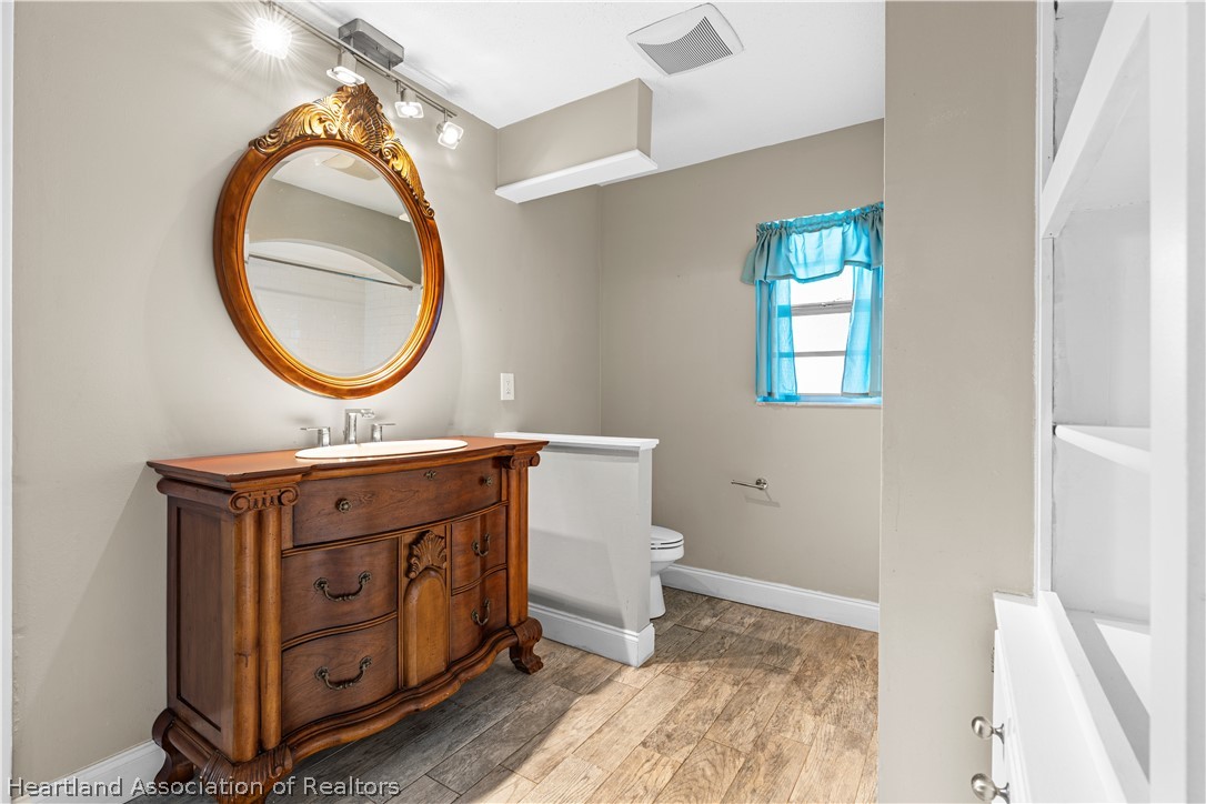 7100 Coral Ridge Road Sebring, FL 33876 - Photo 34 of 44 a bathroom with a sink and a mirror
