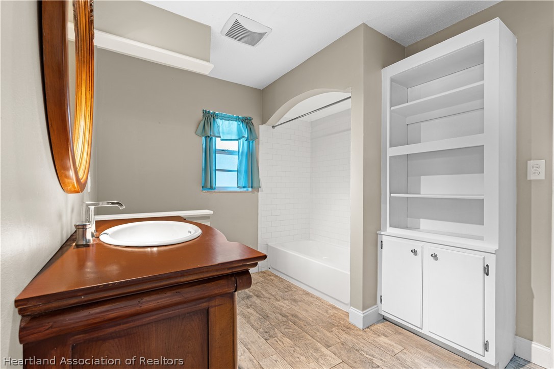 7100 Coral Ridge Road Sebring, FL 33876 - Photo 35 of 44 a bathroom with a sink and a mirror