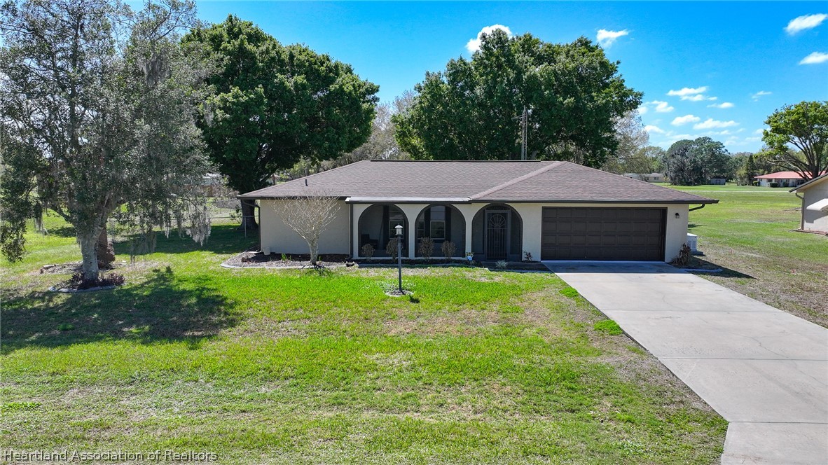 7100 Coral Ridge Road Sebring, FL 33876 - Photo 4 of 44 a house with green field in front of it