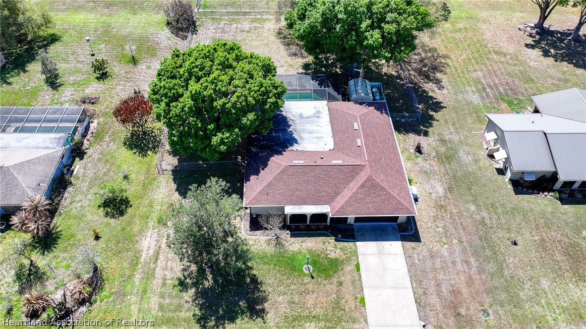 7100 Coral Ridge Road Sebring, FL 33876 - Photo 6 of 44 an aerial view of a house with a yard and large trees