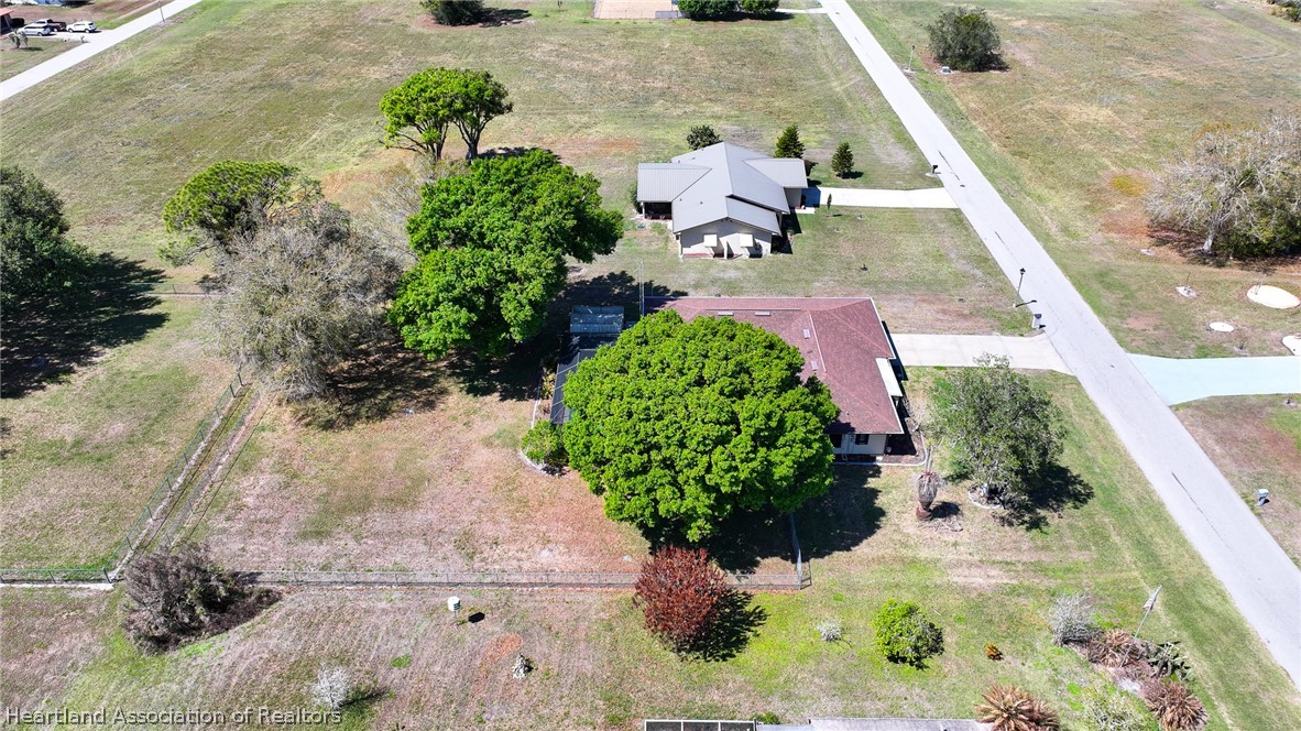 7100 Coral Ridge Road Sebring, FL 33876 - Photo 10 of 44 an aerial view of a house with a yard and a wooden deck