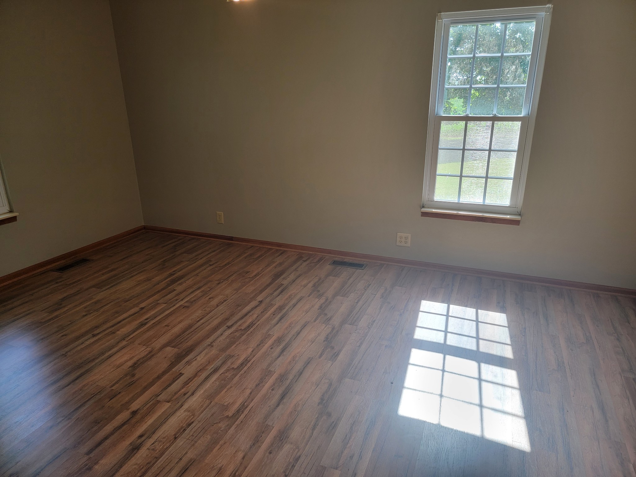 5814 Wayman Dunn Road Springfield, TN 37172 - Photo 25 of 65 an empty room with wooden floor and windows