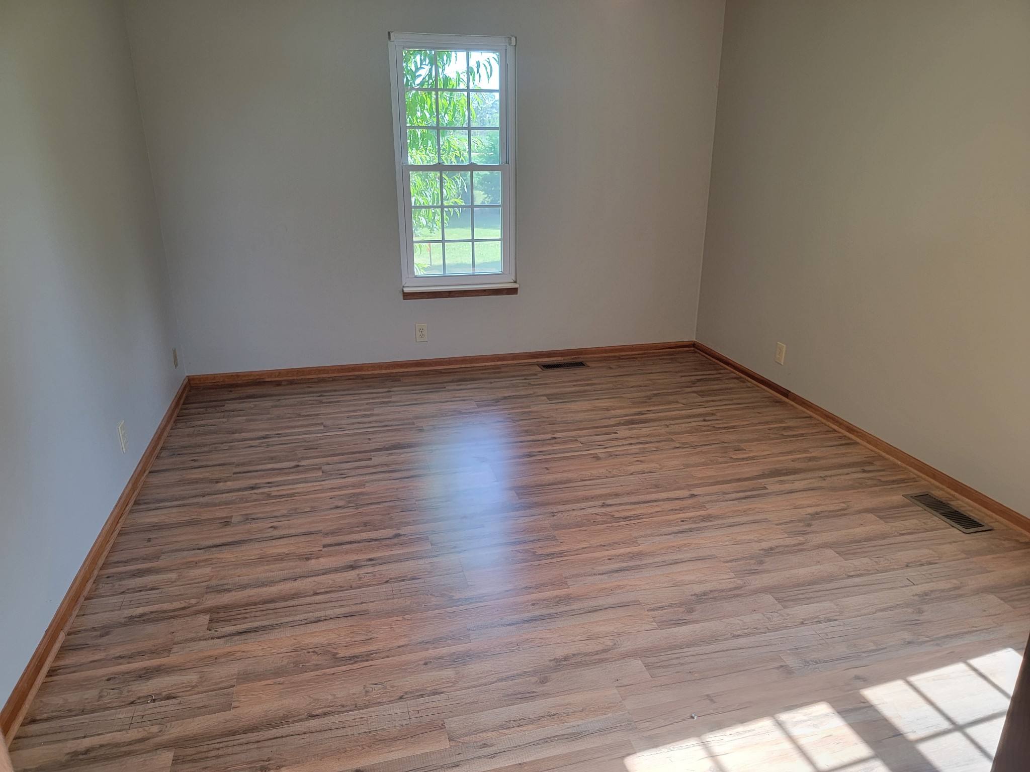 5814 Wayman Dunn Road Springfield, TN 37172 - Photo 26 of 65 a view of an empty room with wooden floor and a window