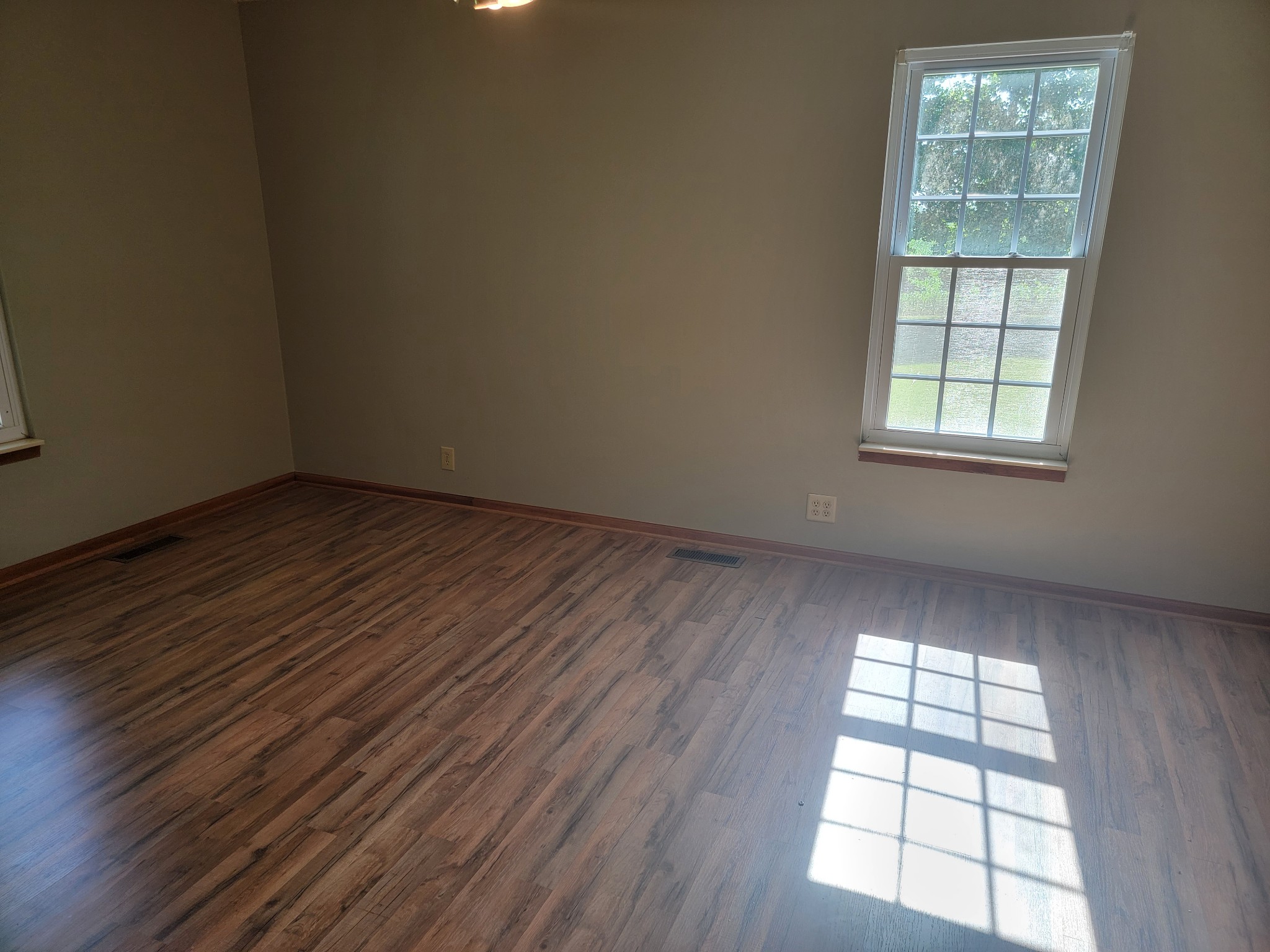5814 Wayman Dunn Road Springfield, TN 37172 - Photo 33 of 65 an empty room with wooden floor and windows