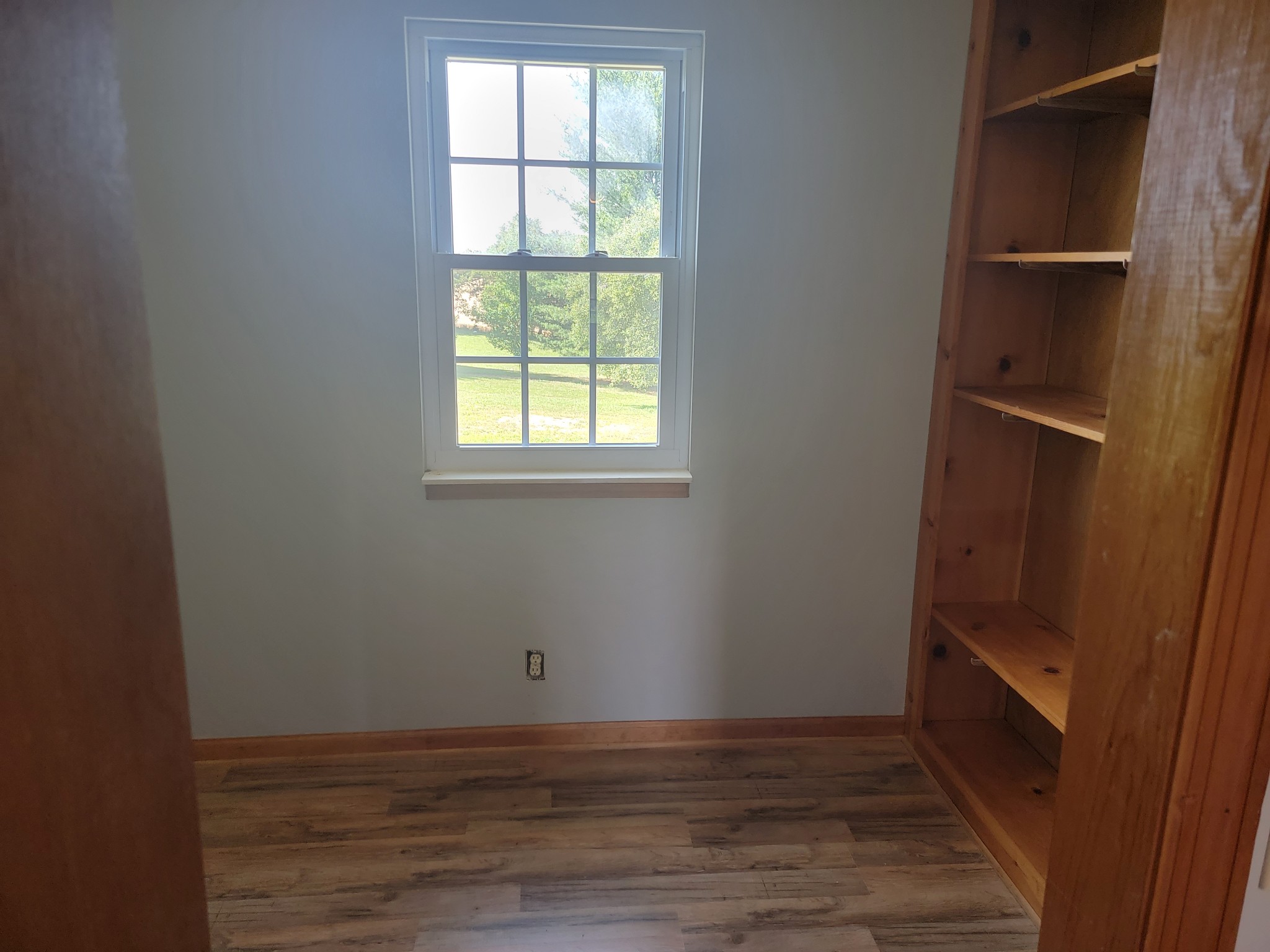 5814 Wayman Dunn Road Springfield, TN 37172 - Photo 38 of 65 an empty room with wooden floor and windows