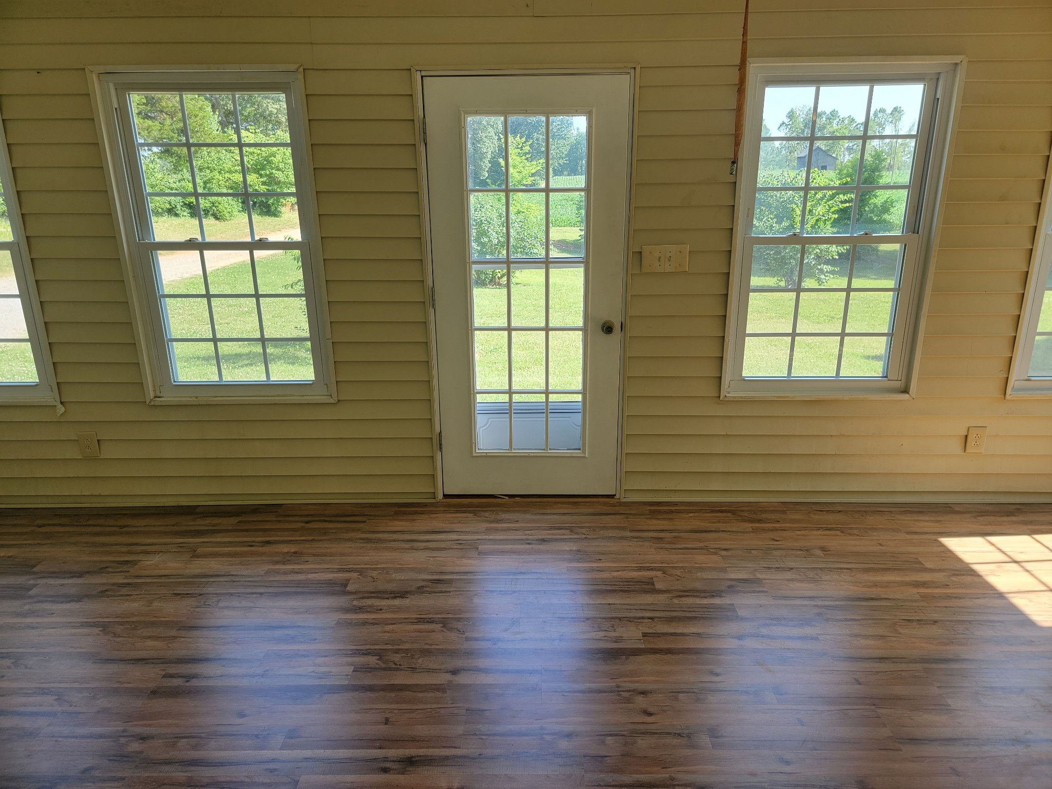 5814 Wayman Dunn Road Springfield, TN 37172 - Photo 7 of 65 a view of an empty room with wooden floor and a window