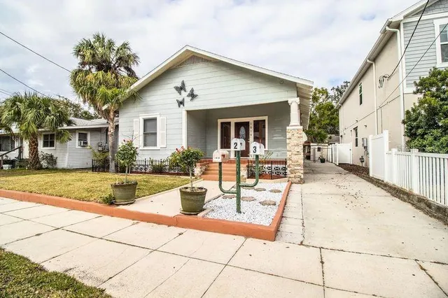 a view of a house with backyard and sitting area