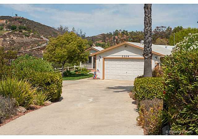 This 1 story home has a long private driveway into the lovely front of your home.