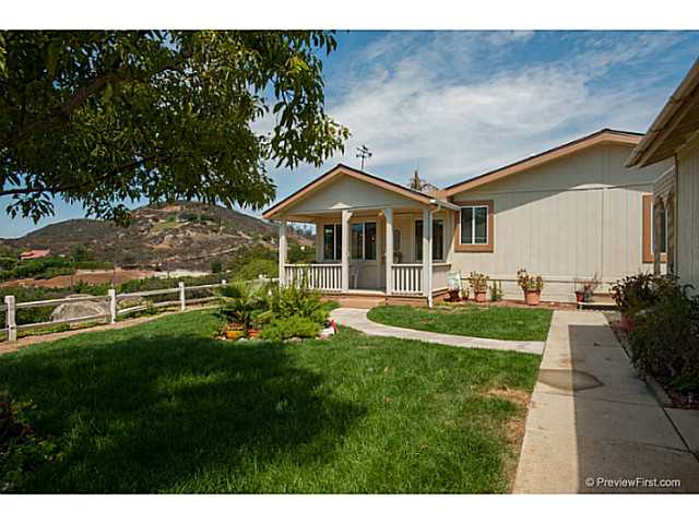 2204 Lookout Mountain Road Fallbrook, CA 92028 - Photo 2 of 25 The covered porch looks out to panoramic views and grassy area in front of the home.