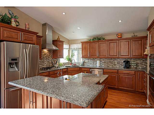 2204 Lookout Mountain Road Fallbrook, CA 92028 - Photo 10 of 25 Slab granite counters, upgraded maple cabinets with soft close design, stained cherry wood finish, designer pulls, custom backsplash...