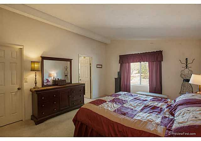 2204 Lookout Mountain Road Fallbrook, CA 92028 - Photo 14 of 25 The master bedroom is large & includes a picture window looking out to the lovely foliage, large walk-in closet with added extra tall shelves which is perfect for the shopper in the family & sunken tub.