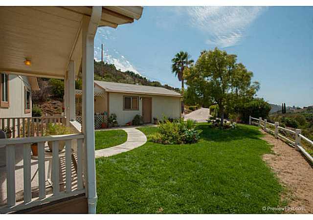 2204 Lookout Mountain Road Fallbrook, CA 92028 - Photo 4 of 25 This photo shows you the 2 car detached garage & grassy area in the front of the home.