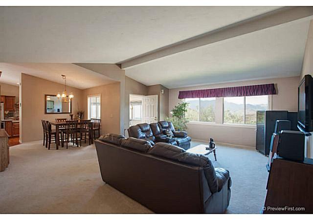 2204 Lookout Mountain Road Fallbrook, CA 92028 - Photo 24 of 25 The open floor plan of the main home includes the Living Room which has vaulted ceiling, custom paint & large picture windows to admire the extensive views.