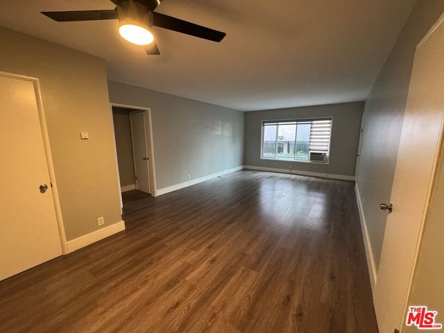 a kitchen with granite countertop stainless steel appliances a sink stove top oven and microwave