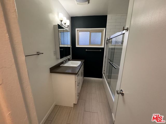 a bathroom with a tub and shower
