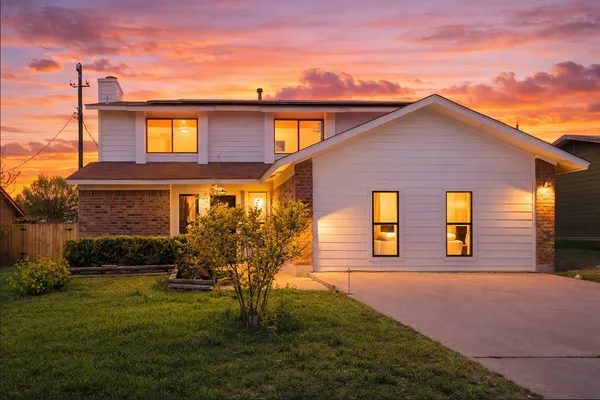 a front view of a house with a yard
