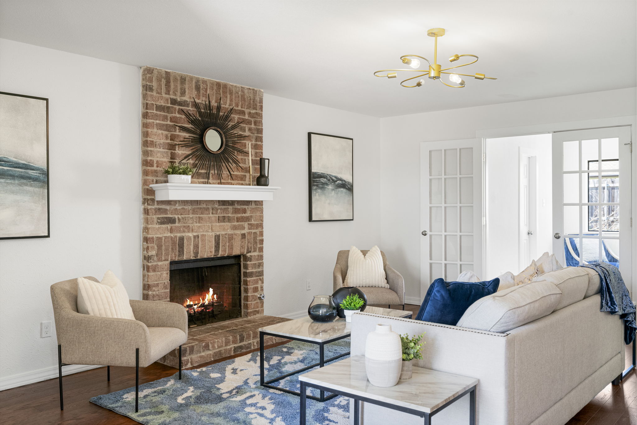 13004 Esplanade Street Austin, TX 78727 - Photo 19 of 36 Living room with wood finished floors, a fireplace, and a chandelier