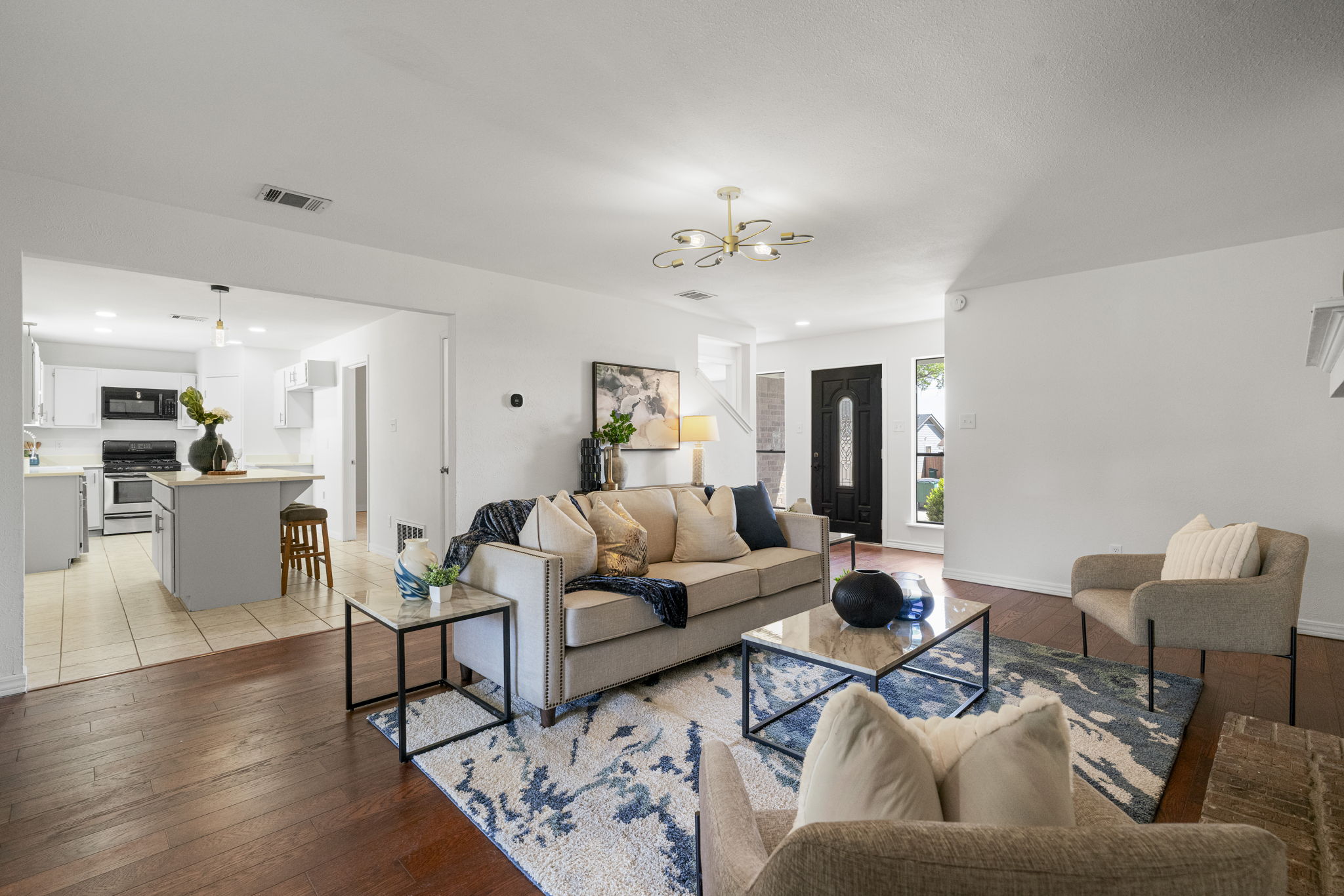 13004 Esplanade Street Austin, TX 78727 - Photo 20 of 36 Living area featuring light wood-style flooring and a chandelier