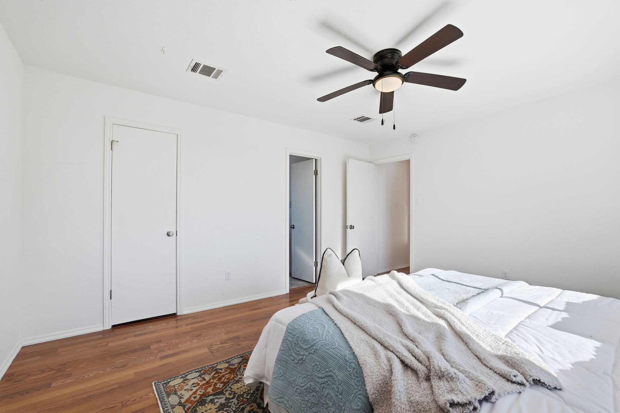 13004 Esplanade Street Austin, TX 78727 - Photo 24 of 38 a bedroom with a bed and a ceiling fan