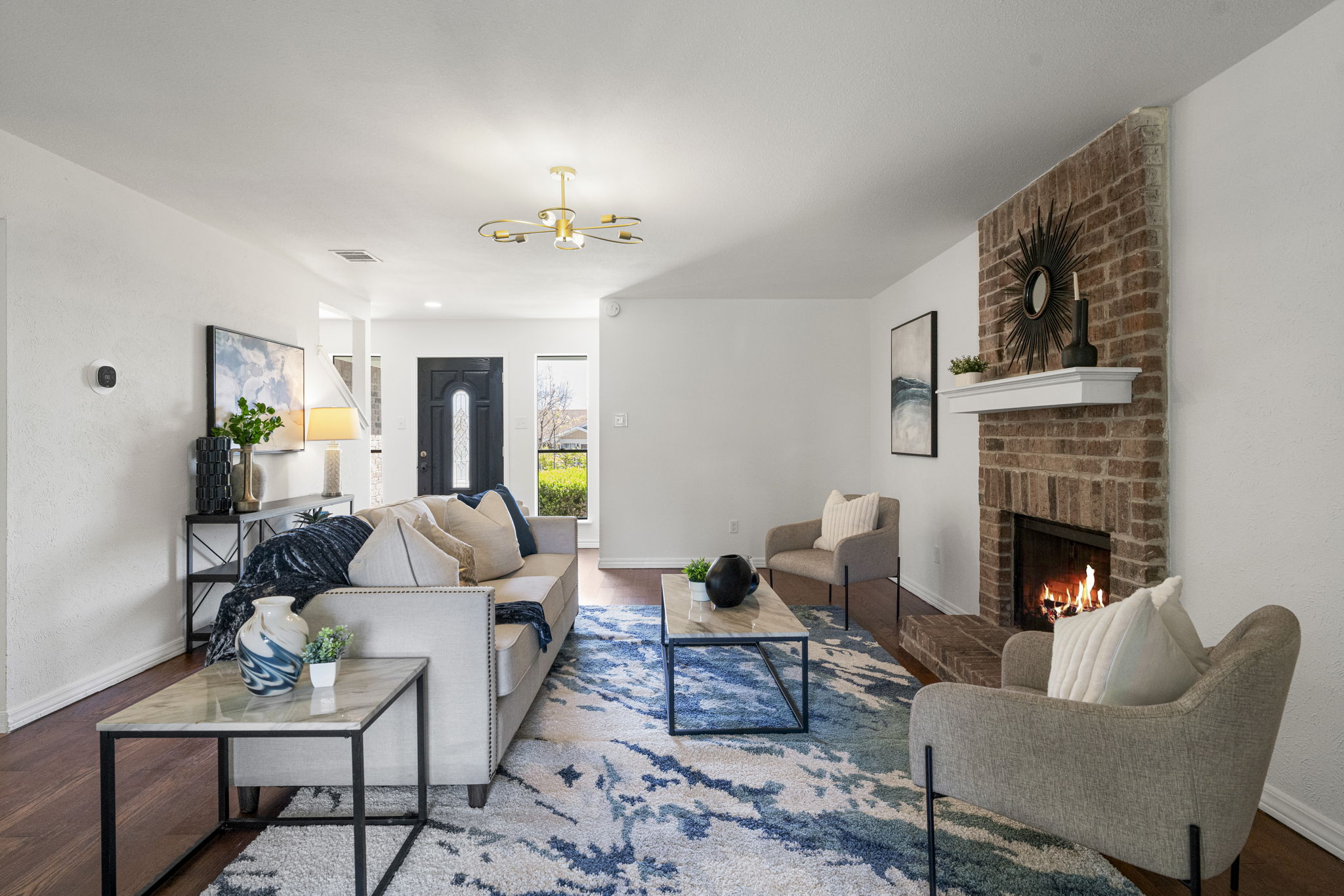 13004 Esplanade Street Austin, TX 78727 - Photo 3 of 36 Living area featuring wood finished floors and a brick fireplace