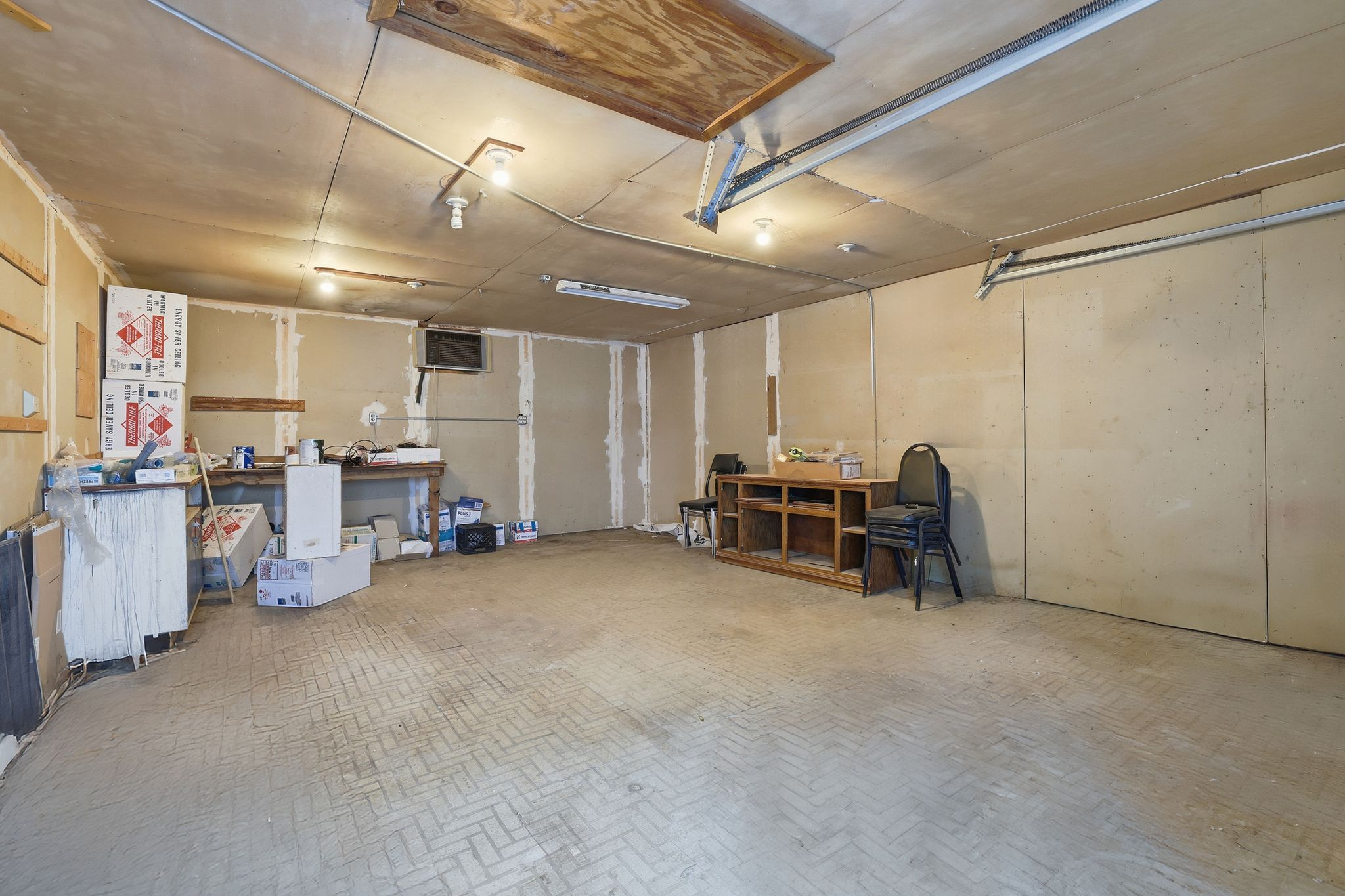 13004 Esplanade Street Austin, TX 78727 - Photo 33 of 36 Large garage/workshop offering ample room for parking, storage, or a workshop setup, with built-in shelving and utility access. - NOT INCLUDED IN SF.