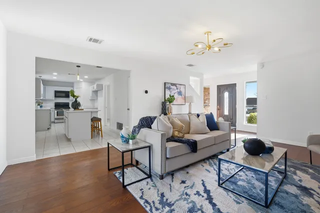 a living room with furniture a dining table and chairs