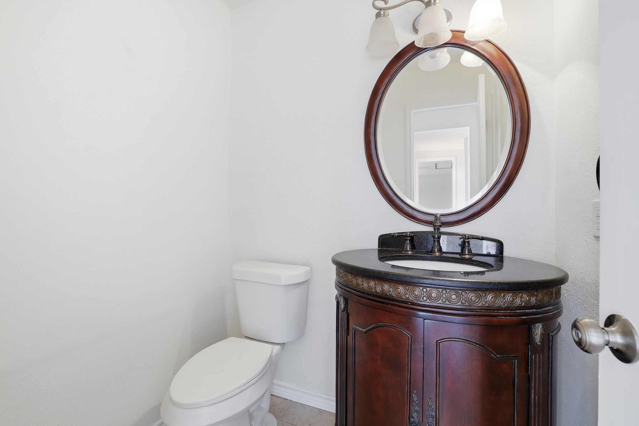 13004 Esplanade Street Austin, TX 78727 - Photo 8 of 38 a bathroom with a granite countertop toilet a sink and a mirror