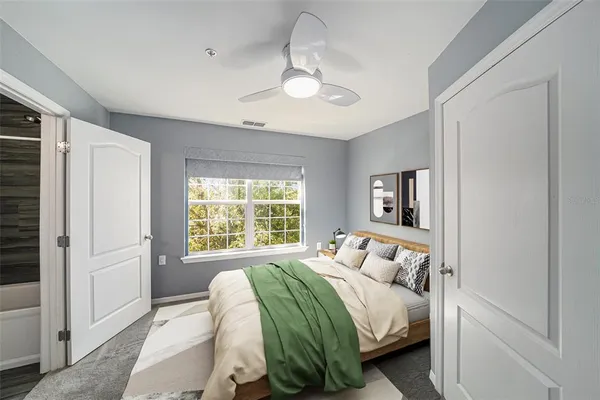 a bedroom with a bed and a window