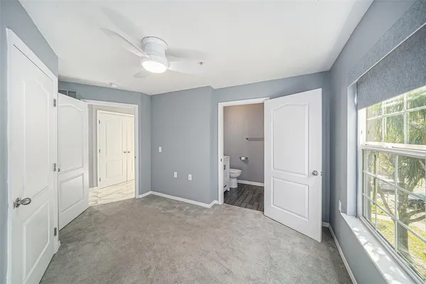 an empty room with windows and closet