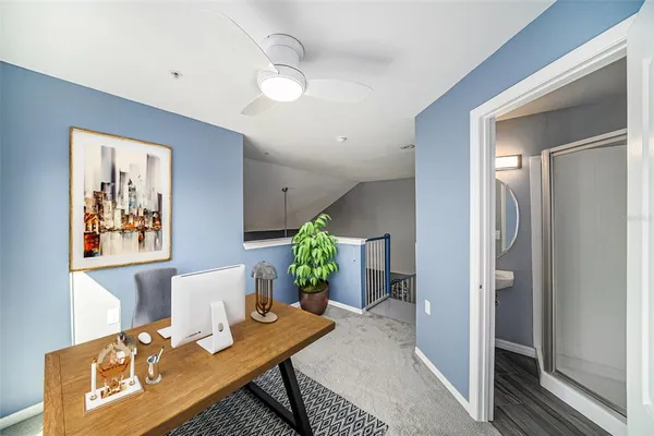 a living room with furniture and a potted plant