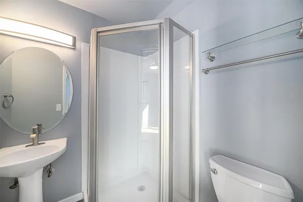 a bathroom with a toilet a sink and a mirror