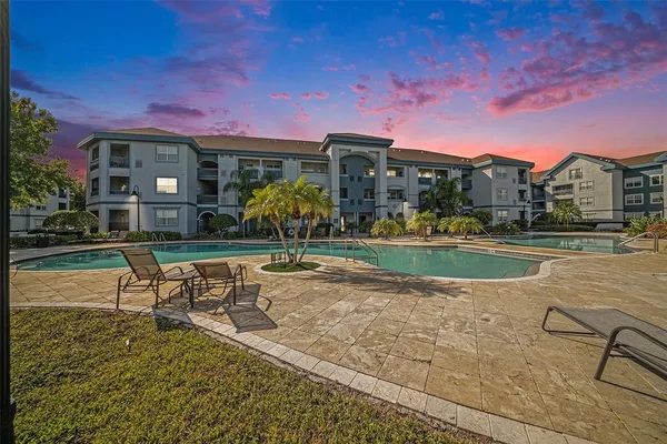 a view of a house with a swimming pool and a yard