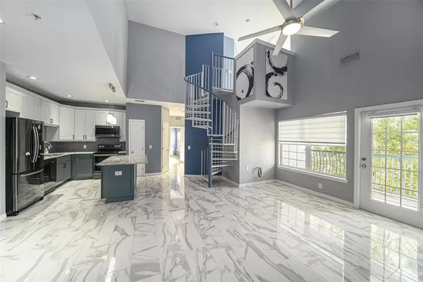 a view of a kitchen and refrigerator in a room